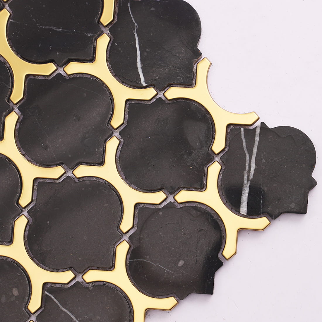 Close-up of black marble gold metal mosaic tile with white veining