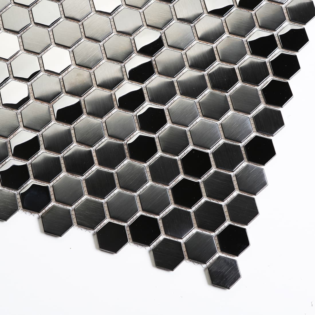 Macro shot of black metallic hexagon tiles showing reflective beveled edges.