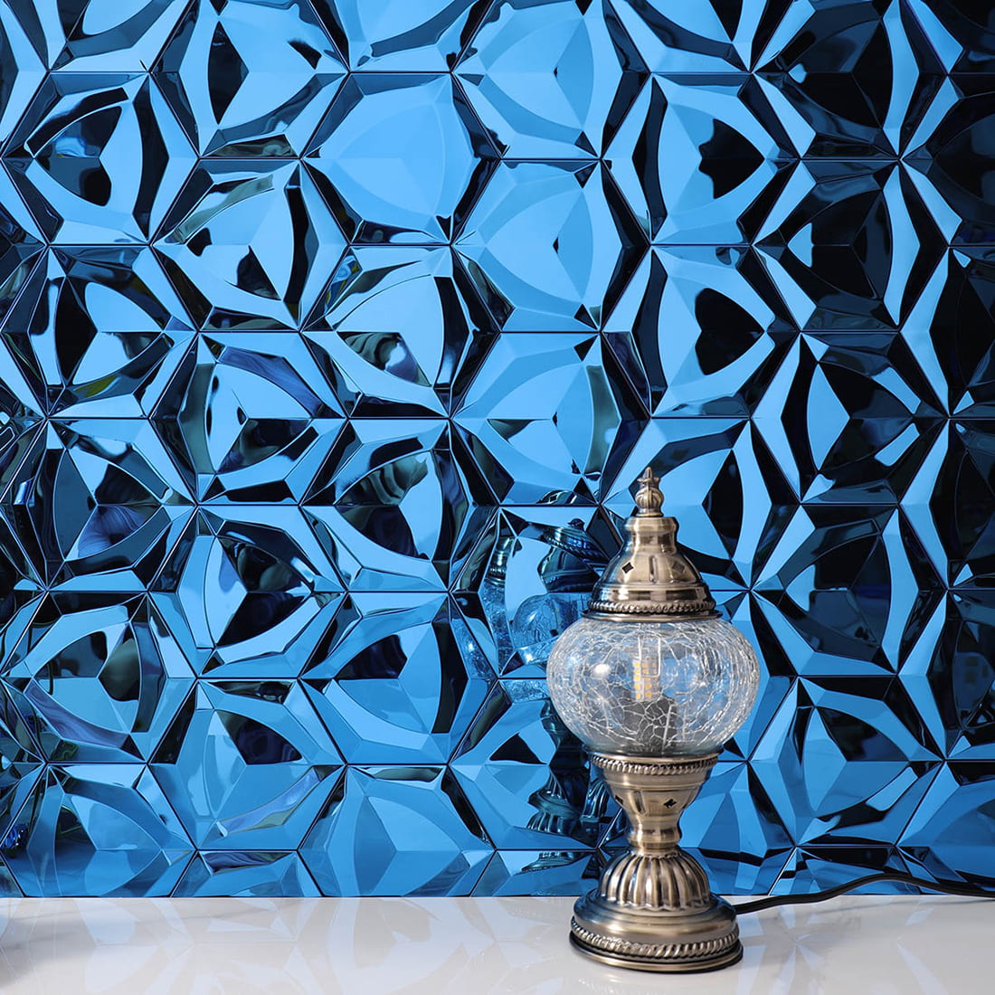 Detailed view of a blue 3D hexagon feature wall with a Turkish style lamp.