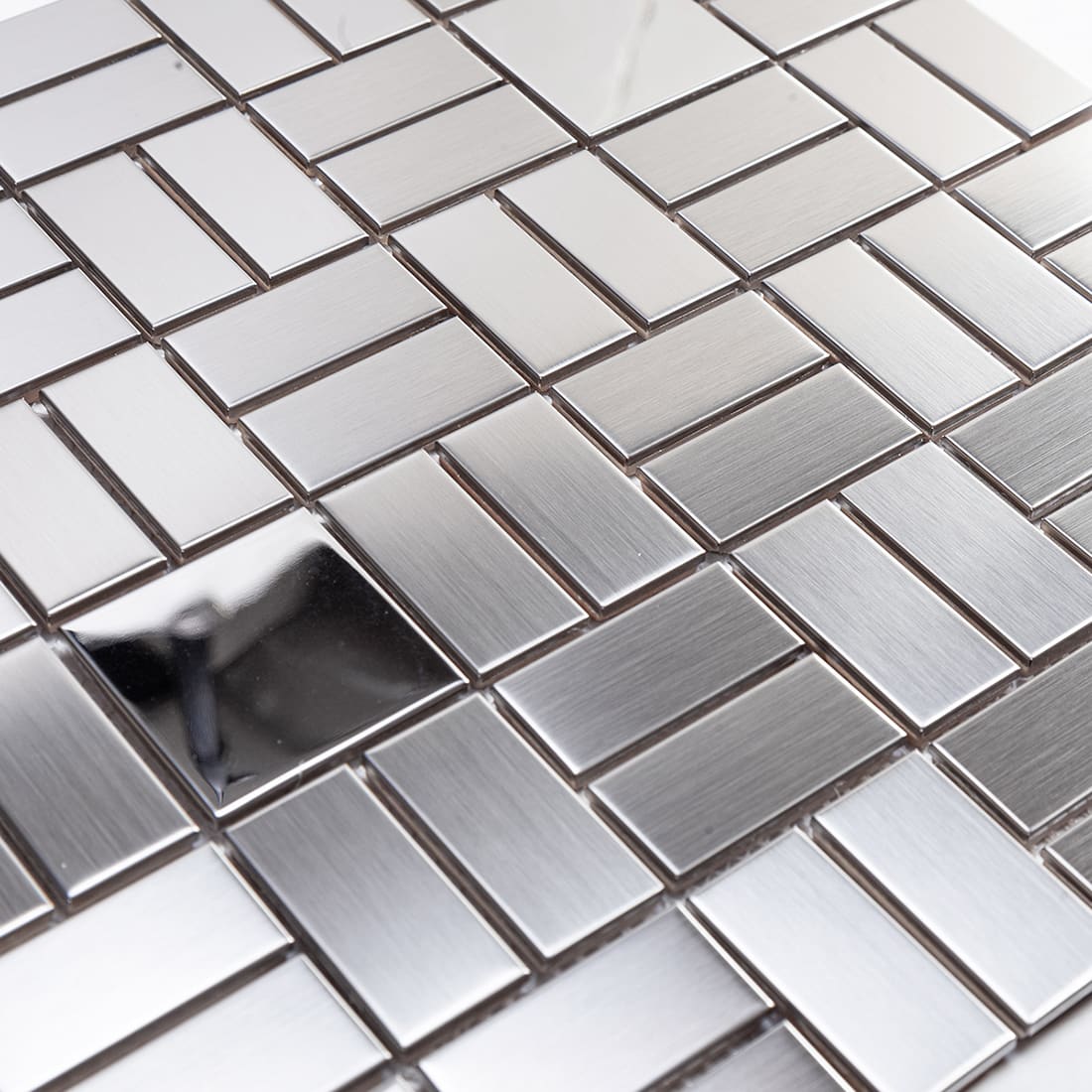 Close up of silver rectangular tiles featuring mixed brushed and mirror finishes.