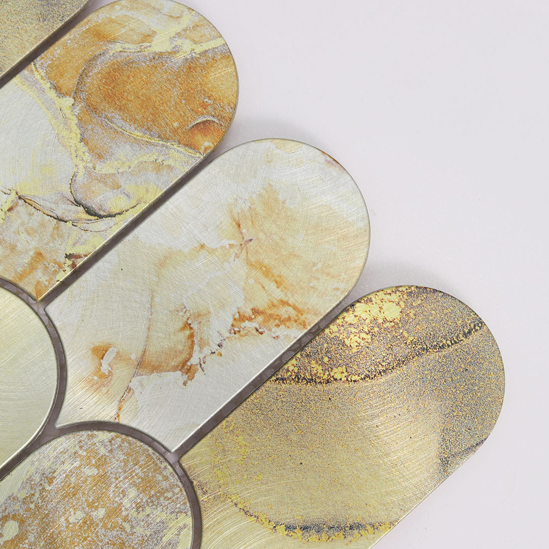 Close-up of cream gold lantern aluminum mosaic tile with brushed texture