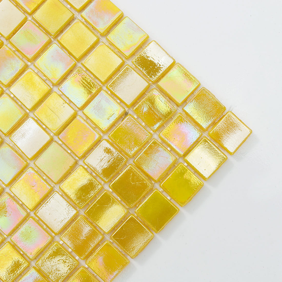 Close-up of pastel iridescent yellow glass mosaic tiles with subtle opalescent sheen