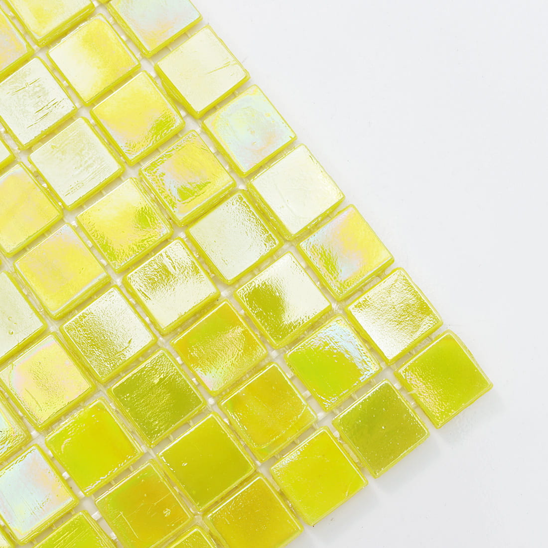 Close-up view of pearlescent lime yellow glass mosaic tiles with glossy iridescent sheen