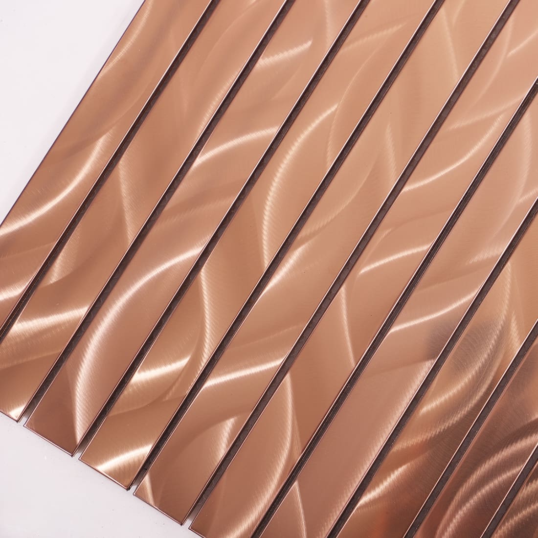 Close-up of rose gold metal strip tiles showing a wavy brushed texture.