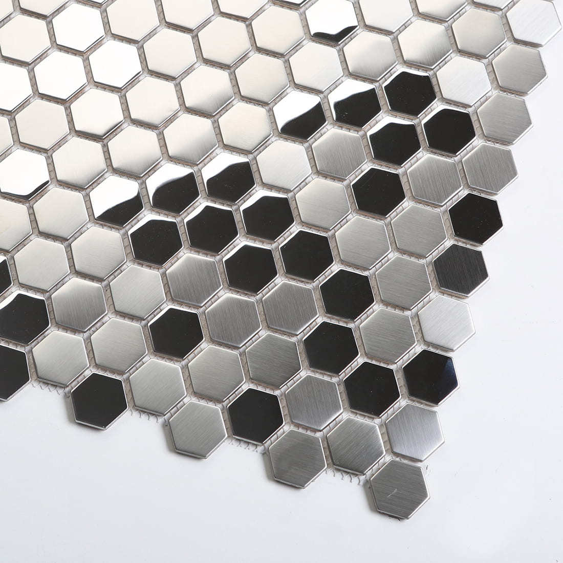 Diagonal view of silver metallic hexagon tiles showing reflective surface details.