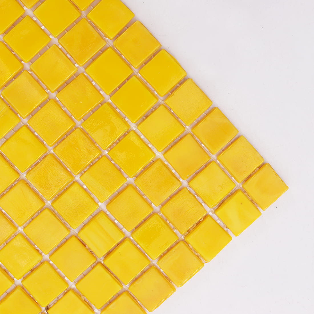  Close-up of vibrant yellow square glass mosaic tiles with glossy surface