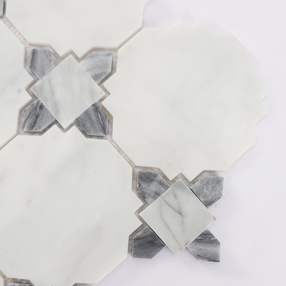 Close view of white octagon marble mosaic with gray corner inlays