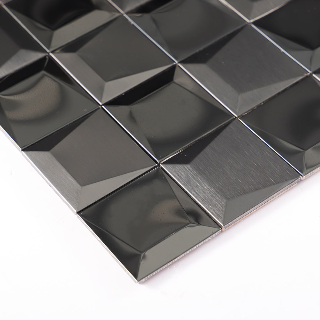 Close-up of black brushed 3D pyramid stainless steel mosaic tile surface