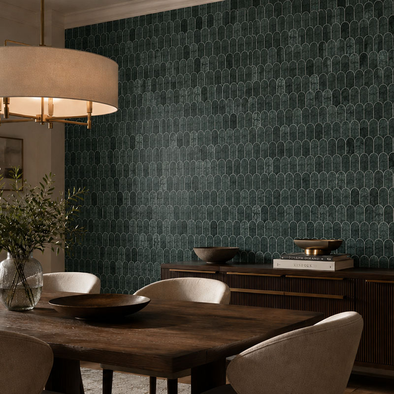 Dark green mosaic wall tile behind a dining table and wood console