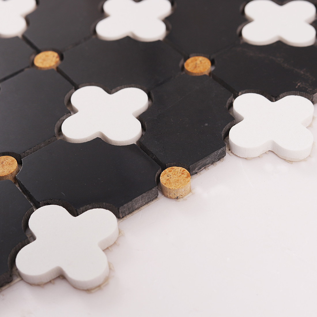 Angled view showing tile thickness, edge profile, and clover insert height