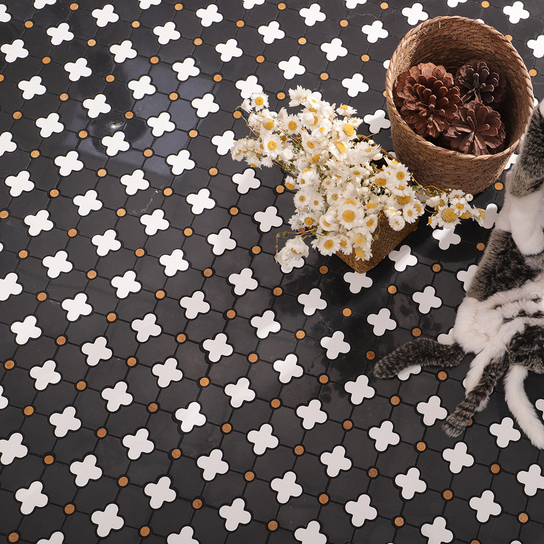 Wide view of installed clover mosaic with flowers and basket props on black surface