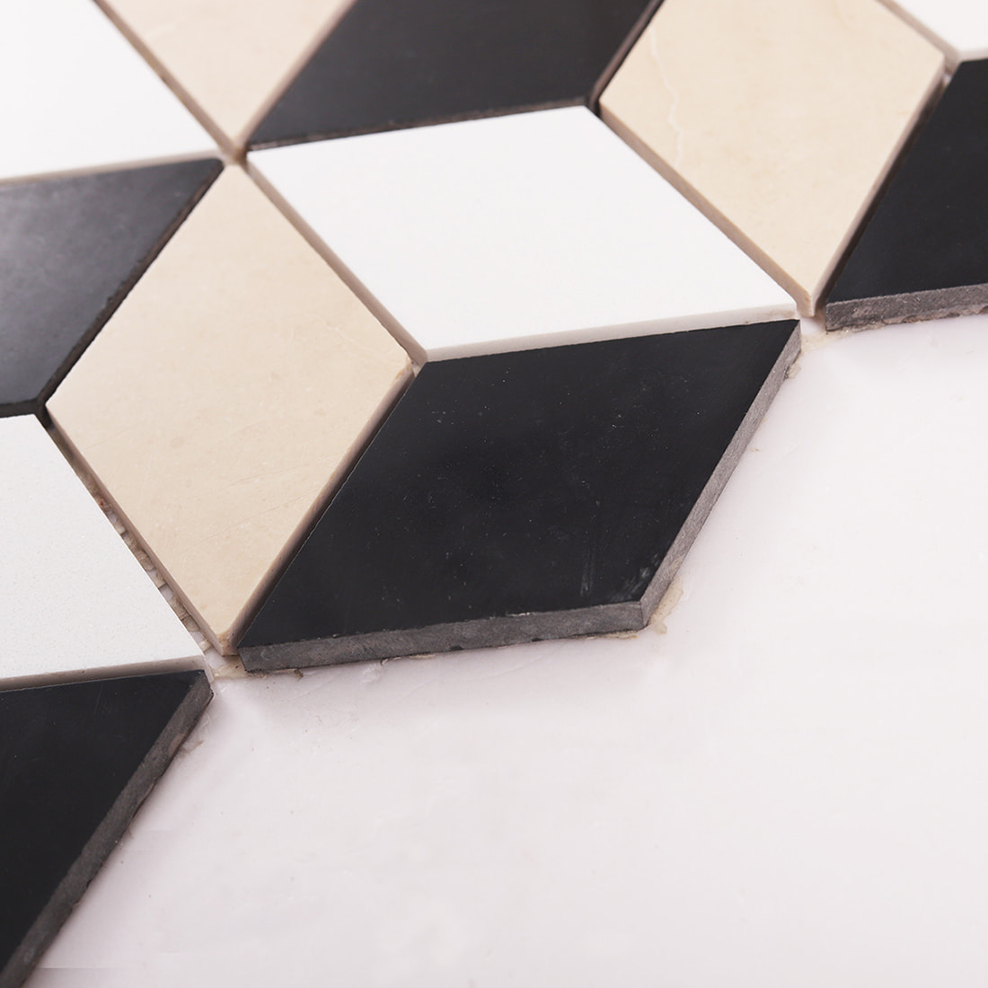 Macro shot of cube mosaic tile edge showing tile thickness and grout