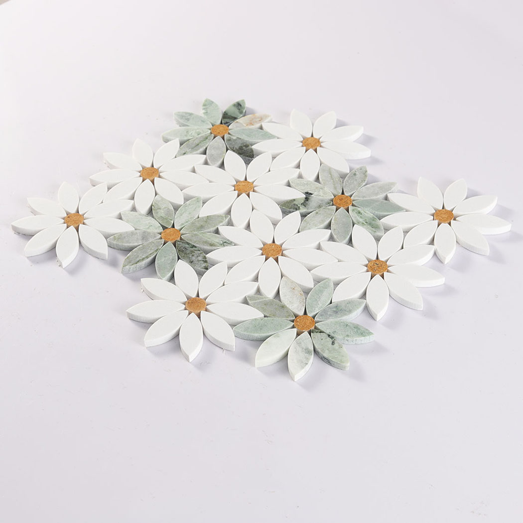Angled view of daisy marble mosaic tile sheet with white and green petals