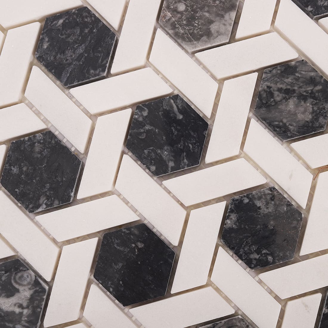 Close-up of polished dark grey marble hexagon mosaic surface texture