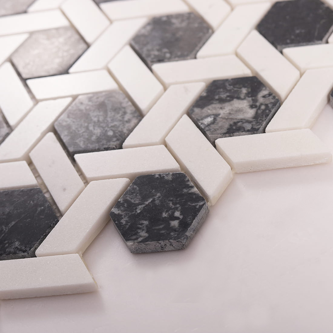 Side angle showing thickness and edges of marble hexagon mosaic tiles