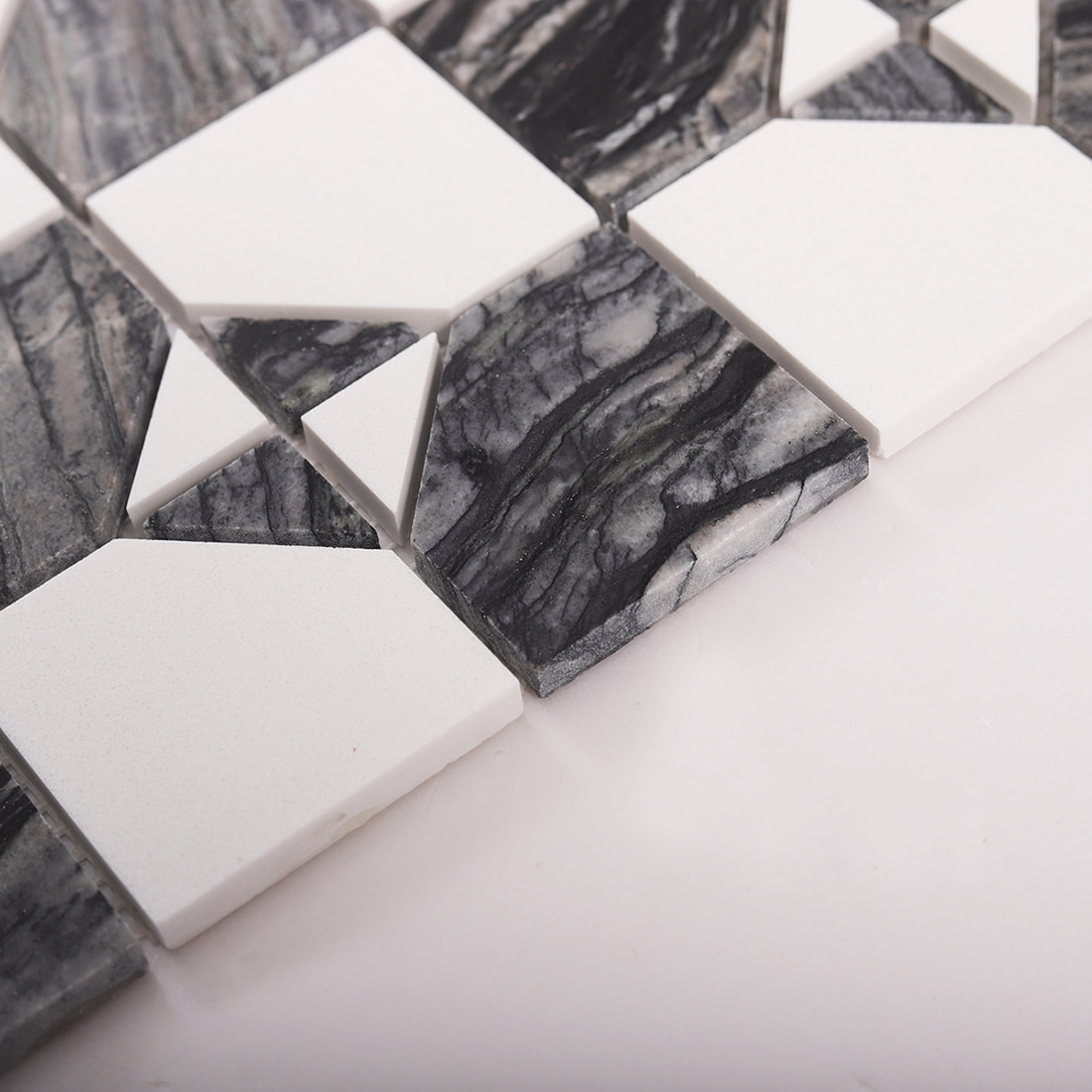 Close up of tile edge thickness on dark gray marble and white square mosaic sheet