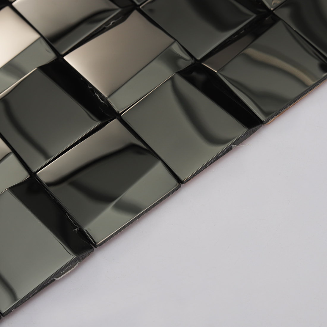 Detailed texture and edge view of a black 3D square stainless steel tile.