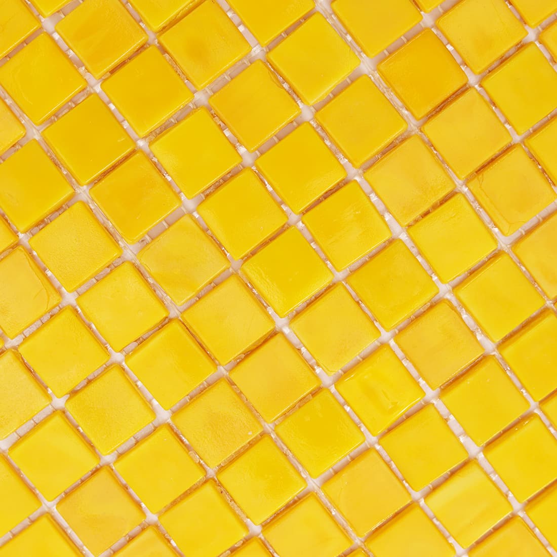 Macro shot of bright yellow glossy glass mosaic tiles with grout lines