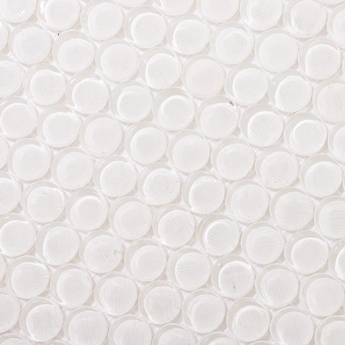 Top-down detail of polished white penny round glass tiles with smooth surfaces.