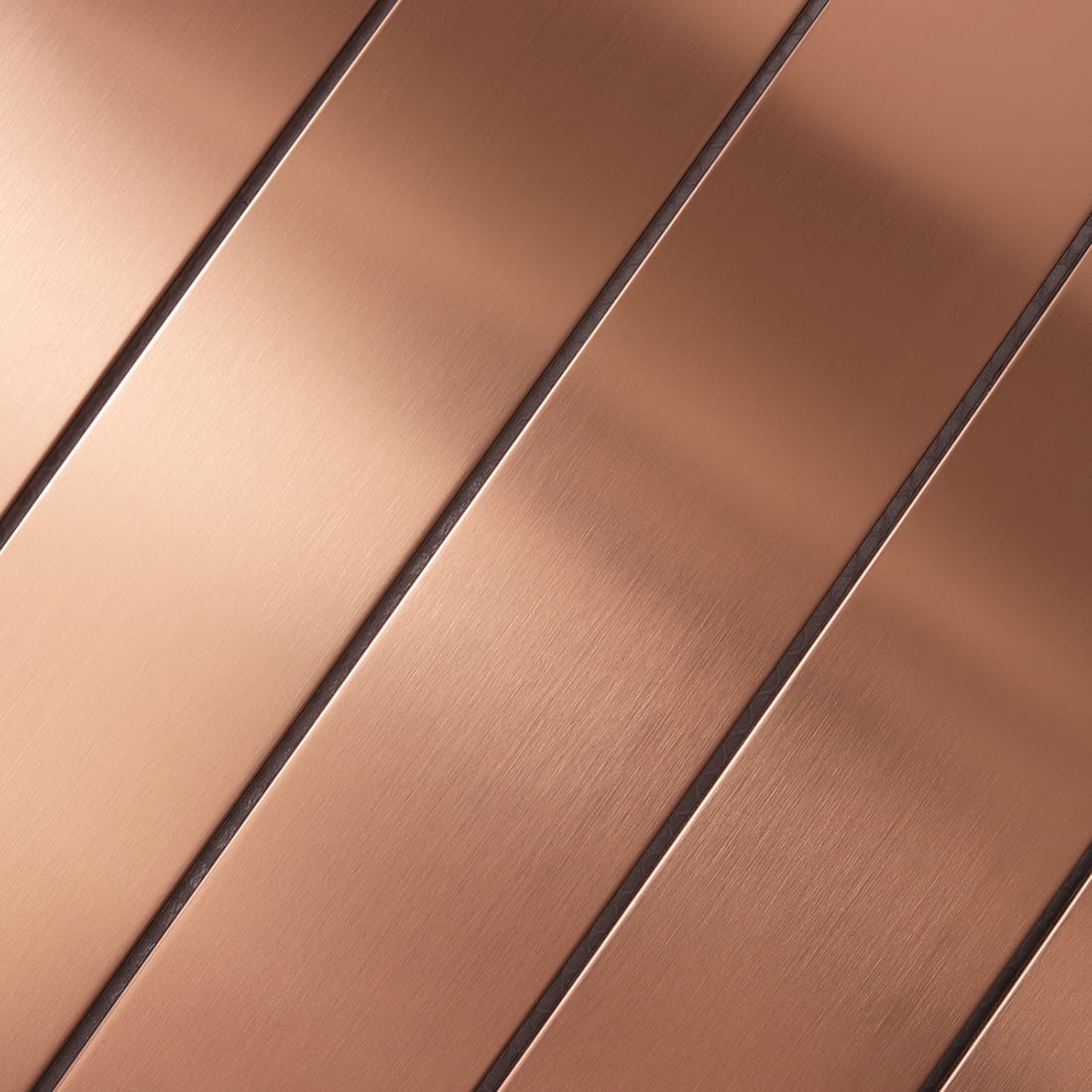 Detailed macro shot of brushed grain on rose gold stainless steel.
