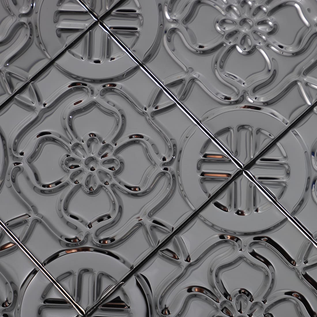 Diagonal close-up of black stainless steel floral tiles