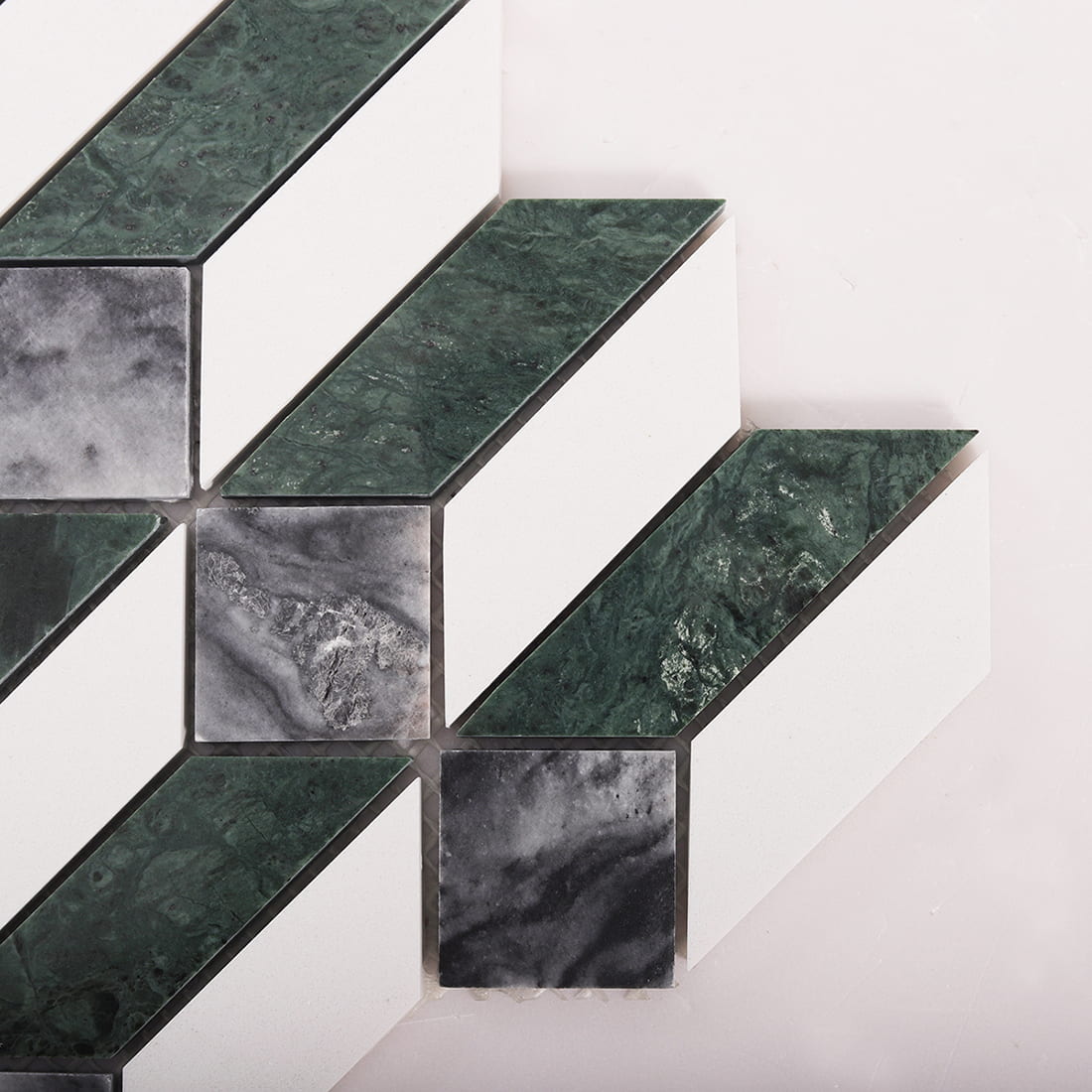 Close-up of diamond marble mosaic tile corner showing green and gray natural stone texture