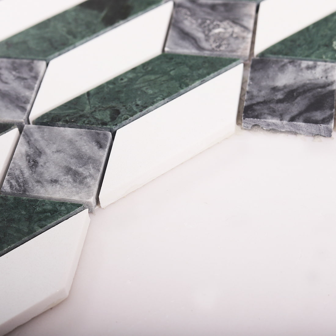 Side view showing thickness of diamond marble mosaic tile with green and white stone