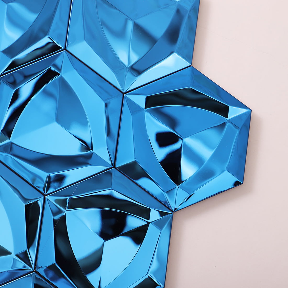 Close-up showing the interlocking edge of blue 3D hexagon mosaic tiles.