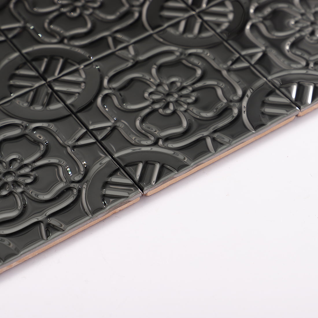 Edge view of black stainless steel tile sheet, showing metal layer