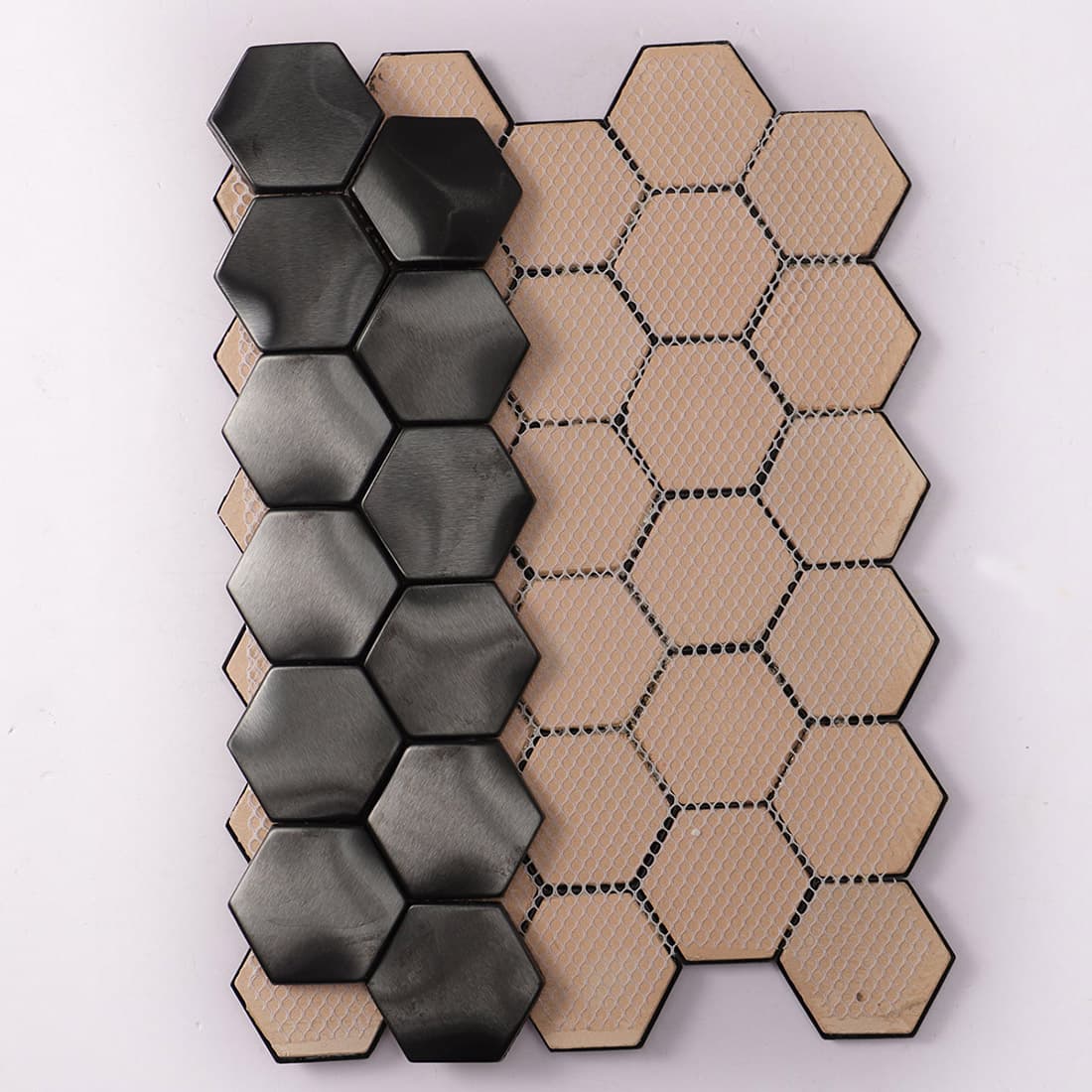 Rear view of black hexagon metal tiles showing the fiber mesh backing