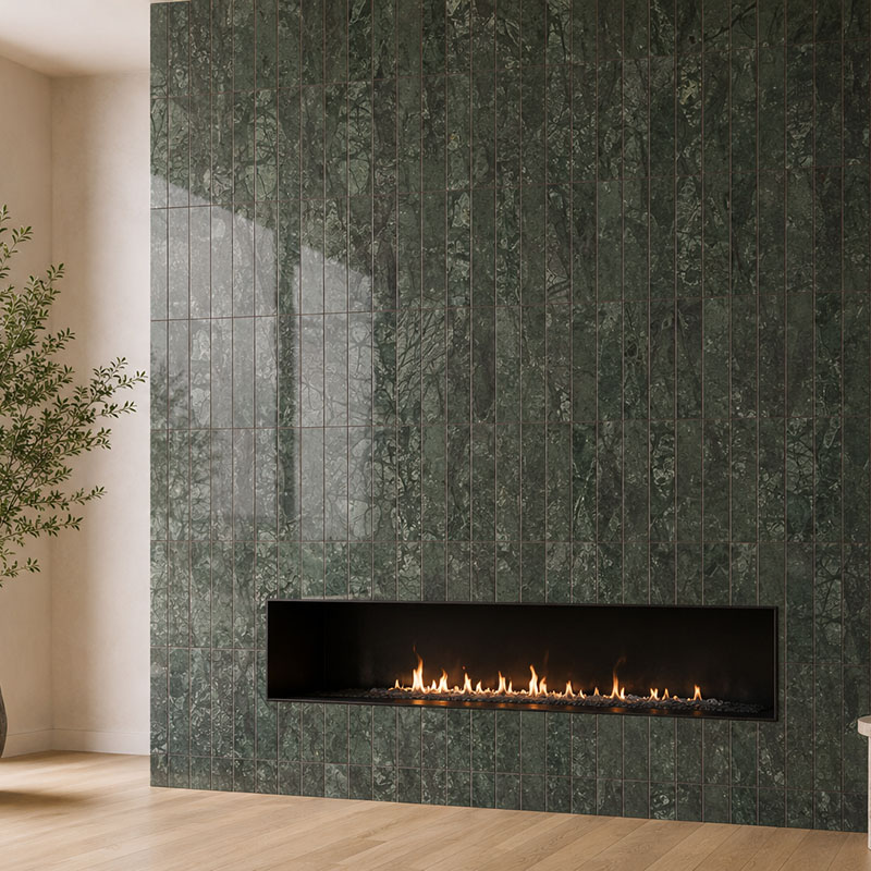 Floor-to-ceiling green marble vertical tile fireplace with a wide linear gas fire