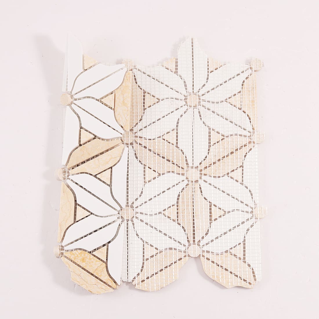 Back view of floral marble mosaic tile sheet with mesh backing