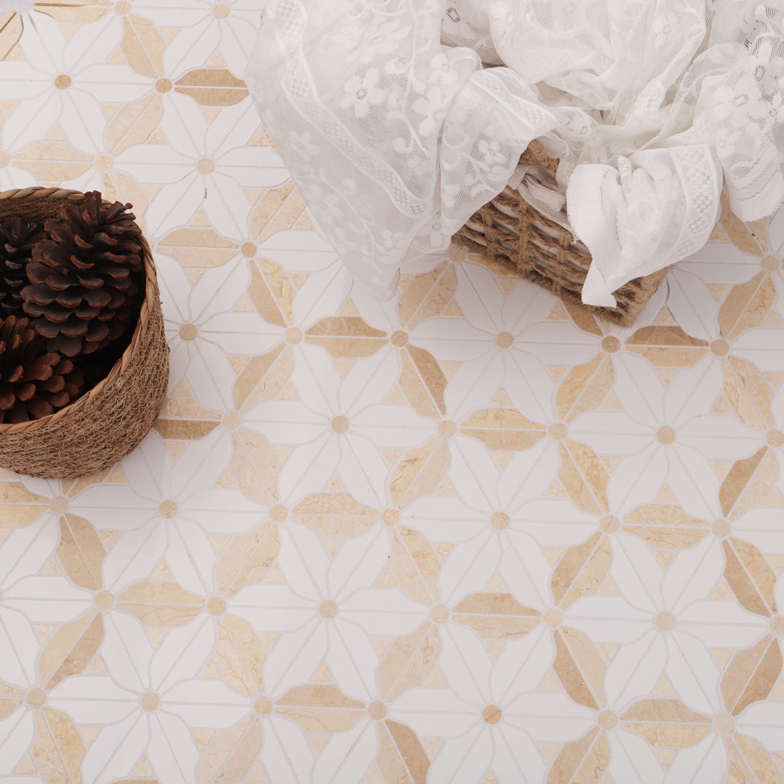 Installed floral mosaic tile with lace cloth and pinecone basket decor