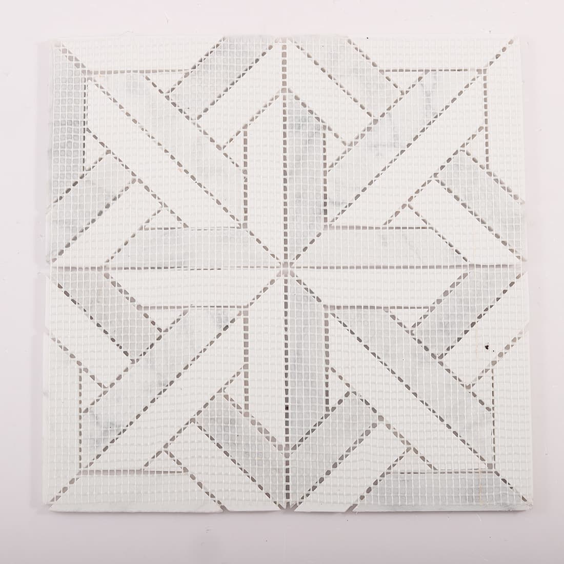 Back view of geometric marble mosaic sheet with fiberglass mesh backing