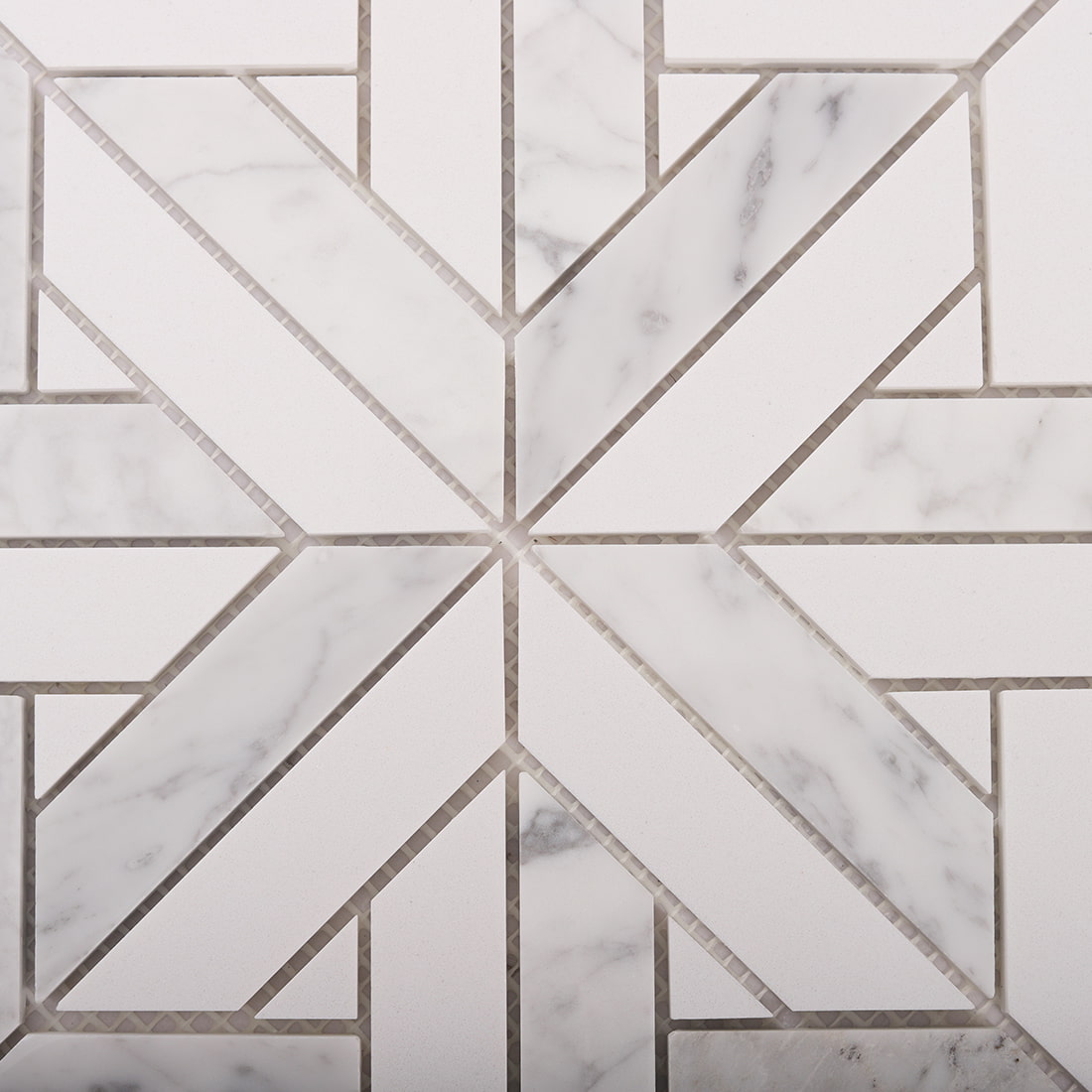 Close up of Carrara marble geometric mosaic star pattern with clean grout lines