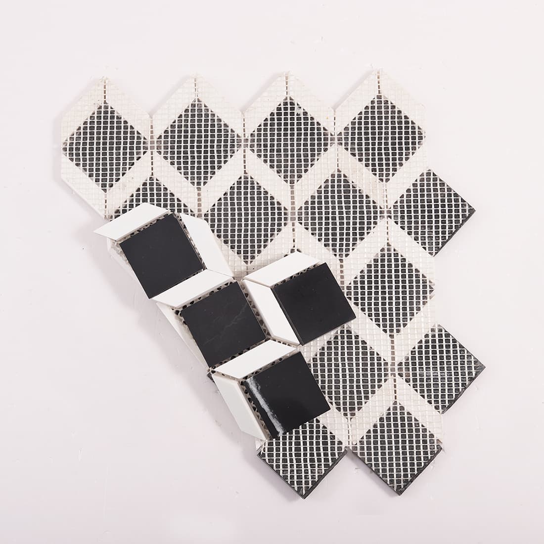 Back view of geometric marble mosaic tile sheet with fiber mesh backing