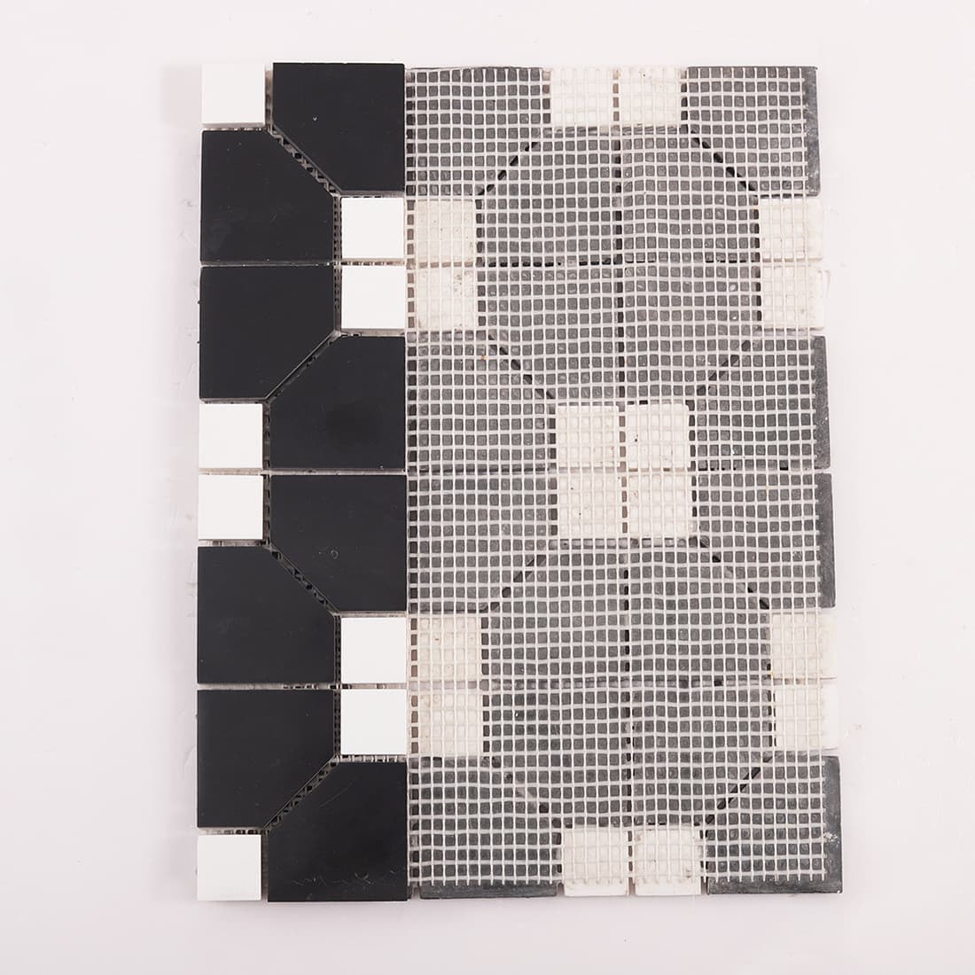Back view of geometric marble mosaic tile sheet with fiber mesh backing