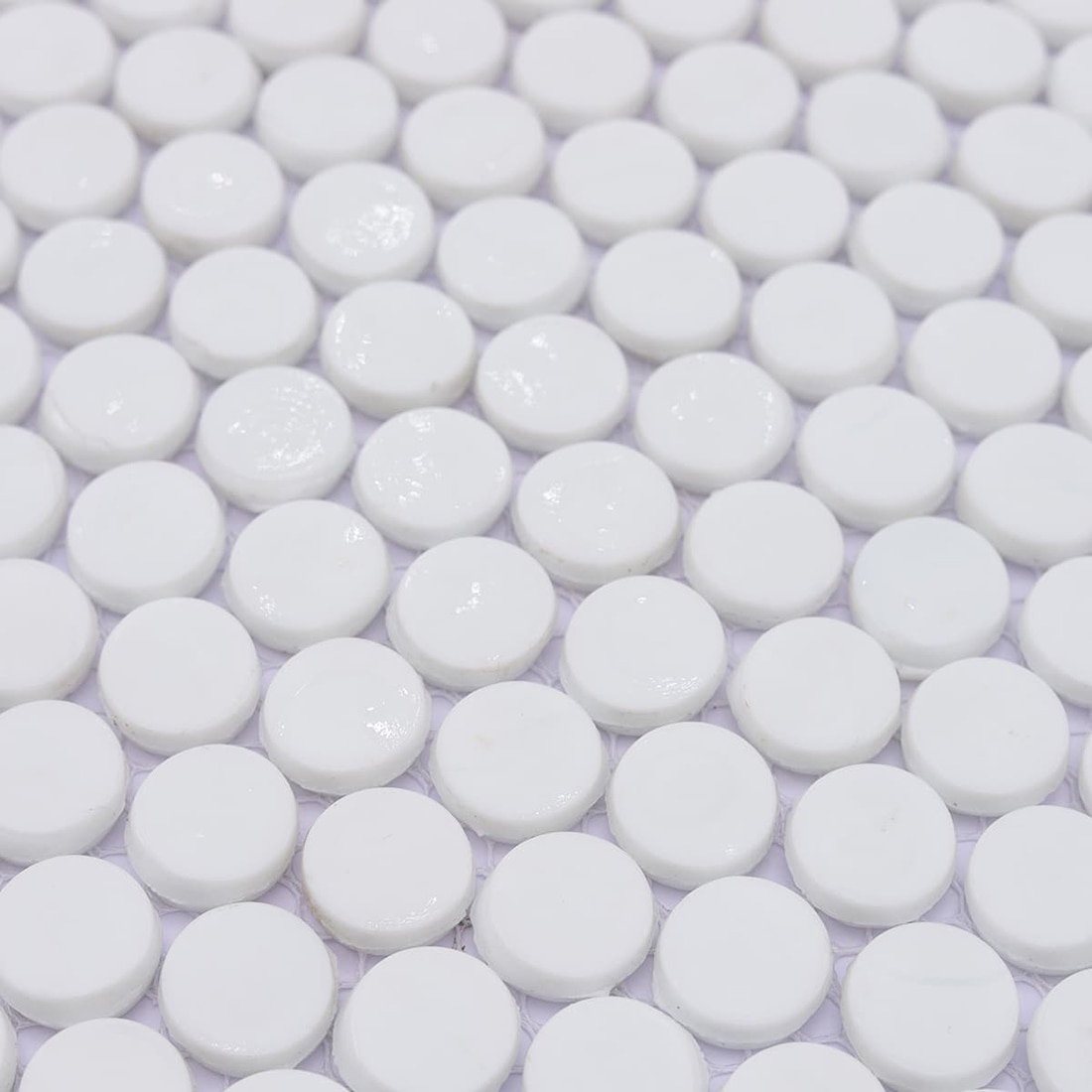 Close-up view of glossy white round penny tile mosaic surface texture