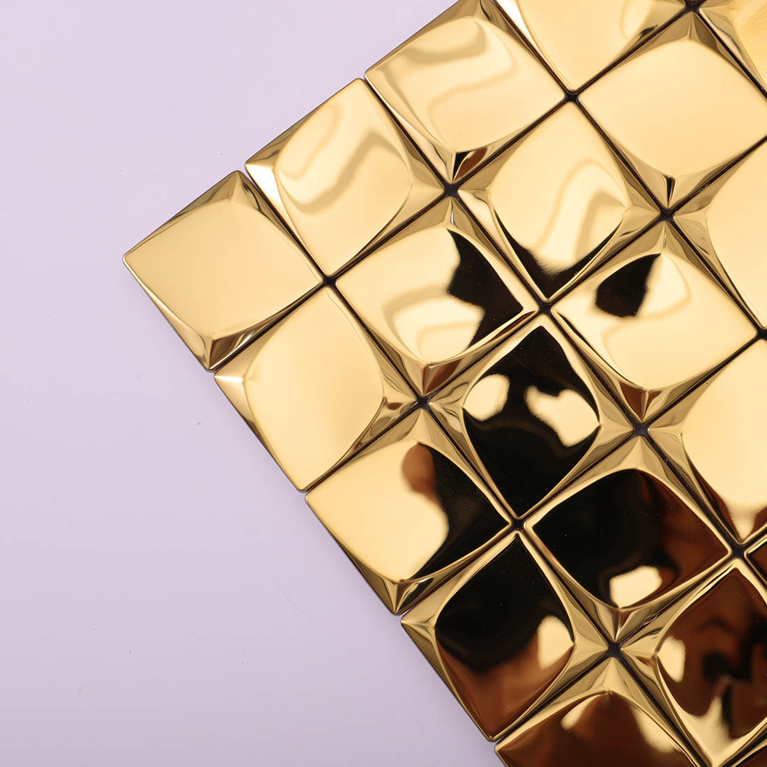 Corner detail of gold 3D square metal mosaic tiles