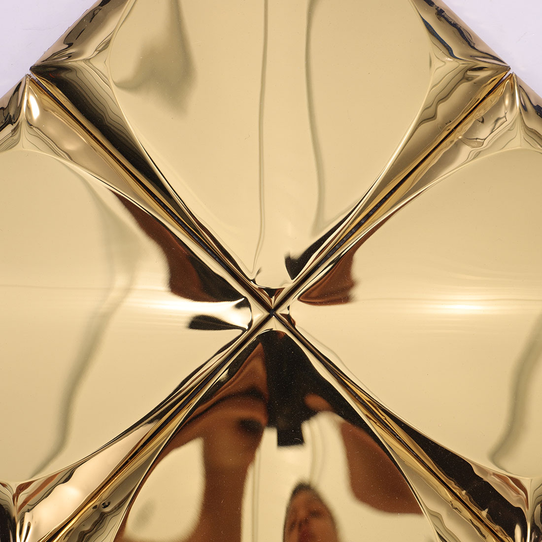 Close-up of gold 3D square stainless steel tiles joined at the center