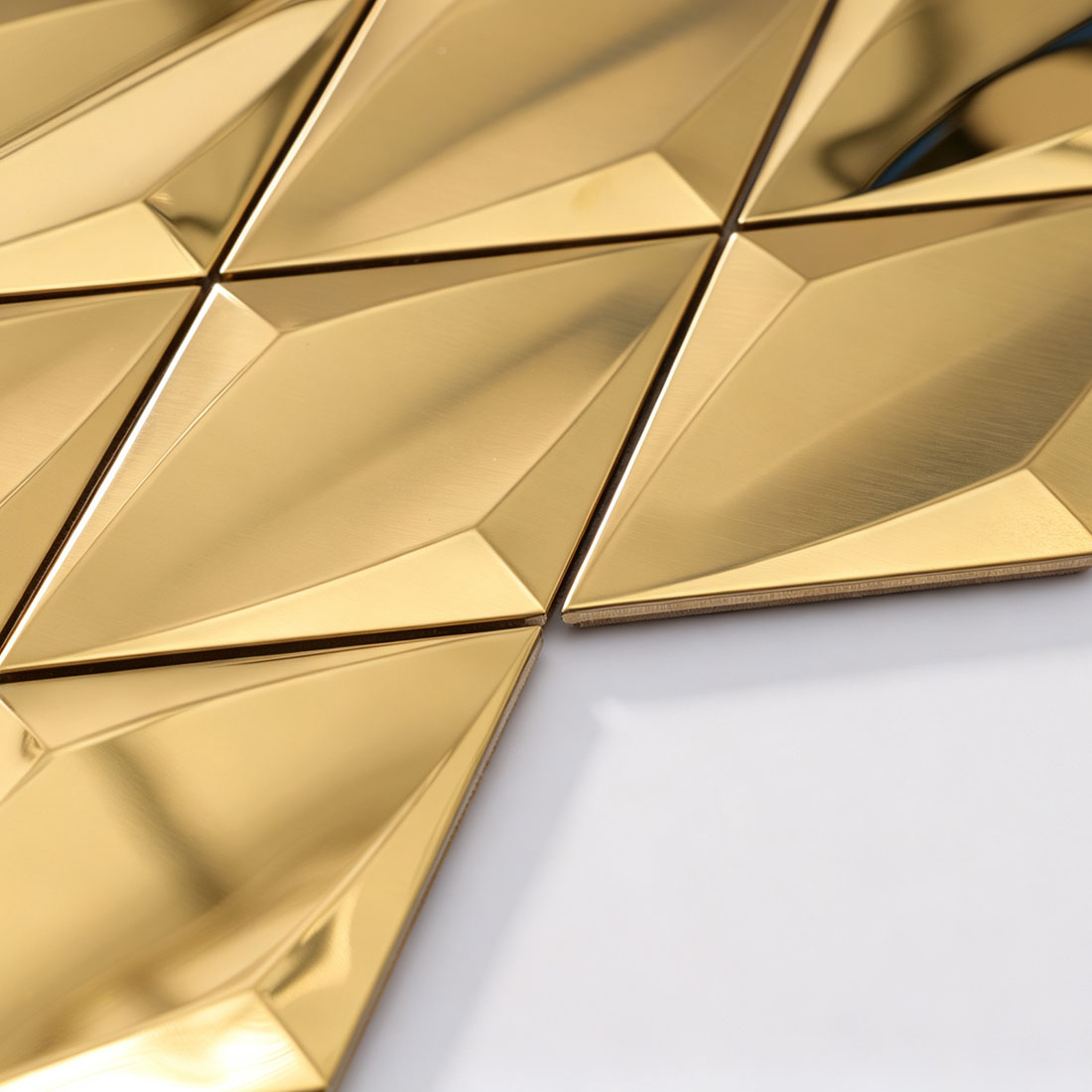 Angled view of gold diamond metal mosaic tile sheet edge