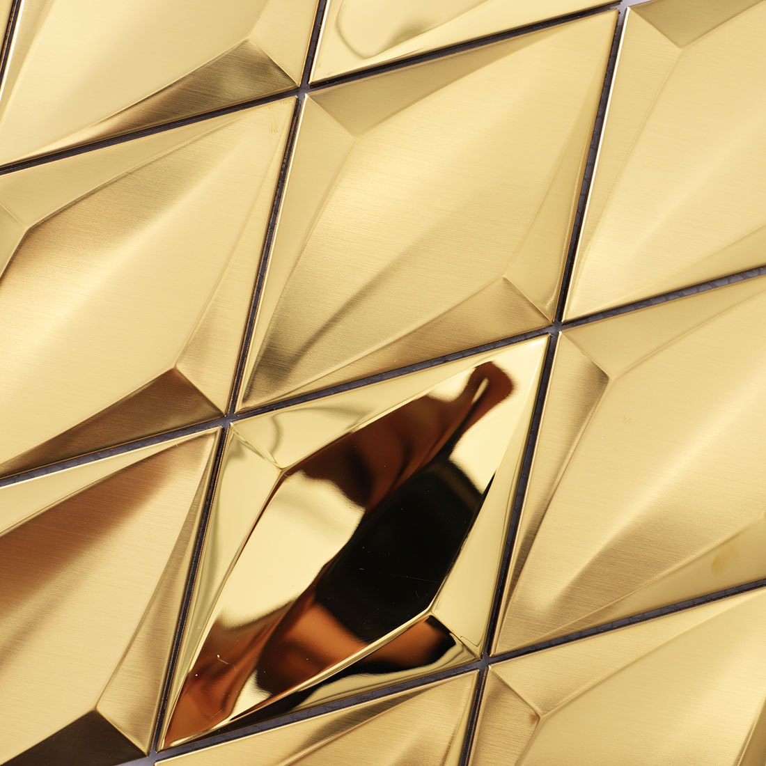 Close-up of gold diamond metal mosaic tile with faceted surfaces