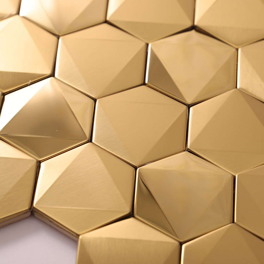 Close-up corner view of gold metallic hexagonal tiles highlighting 3D shape.