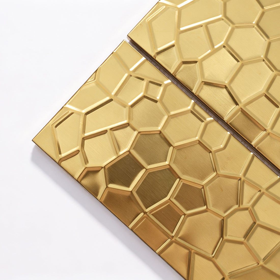 Corner detail of gold rectangle metal tiles with irregular geometric texture