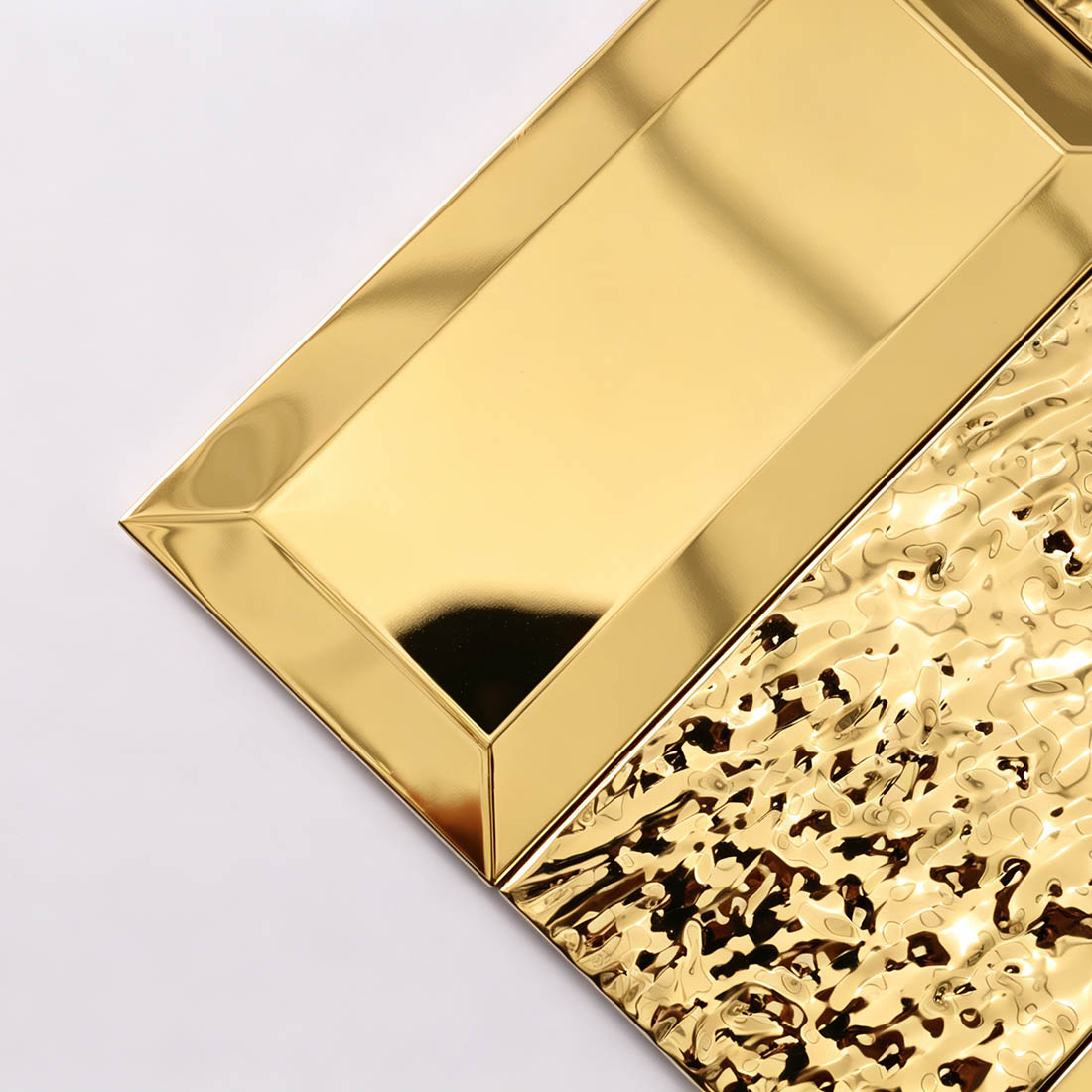 Corner detail of gold hammered rectangle metal mosaic tiles