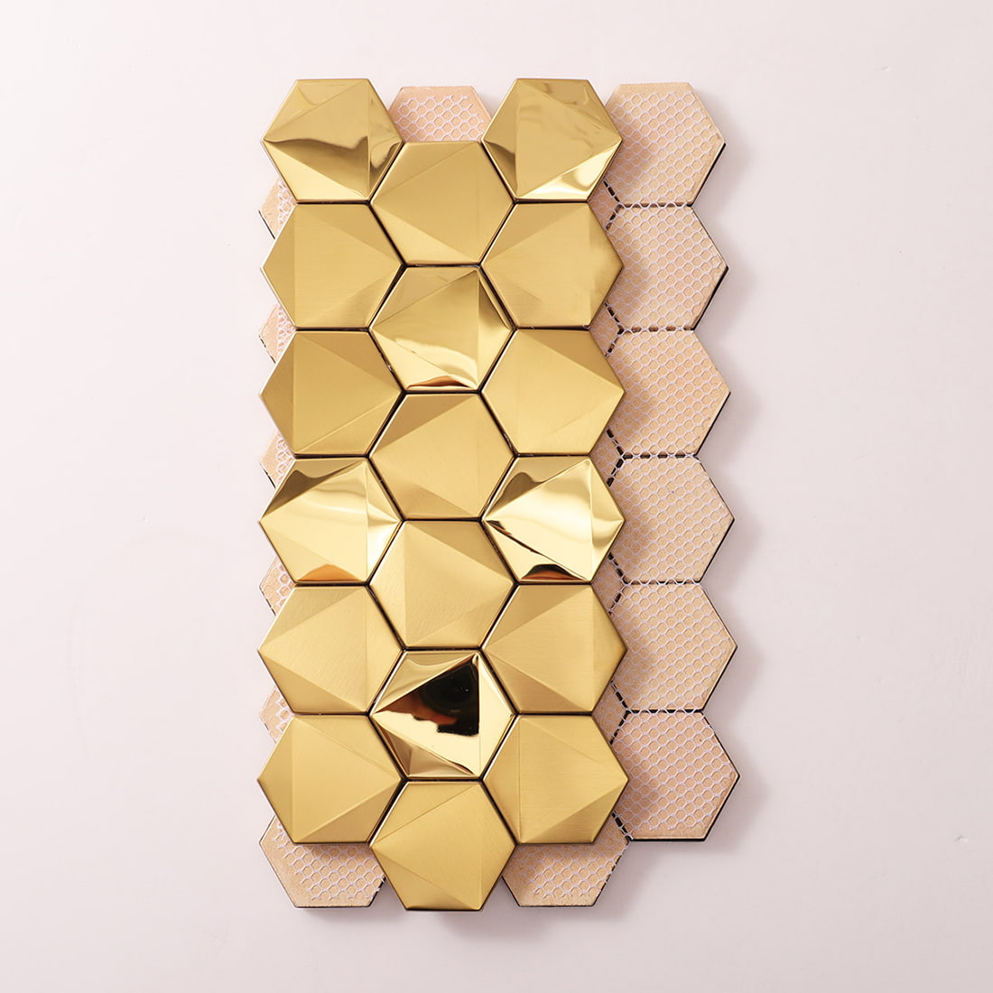Mesh backing and layout of gold hexagon tiles for easy installation.