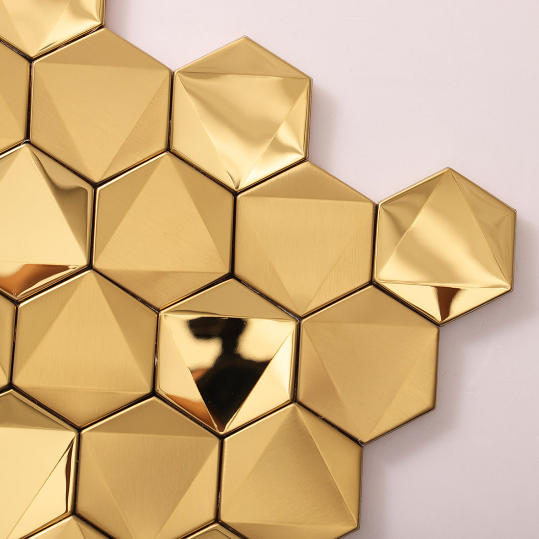 Edge detail of a gold 3D hexagonal tile sheet on a white background.