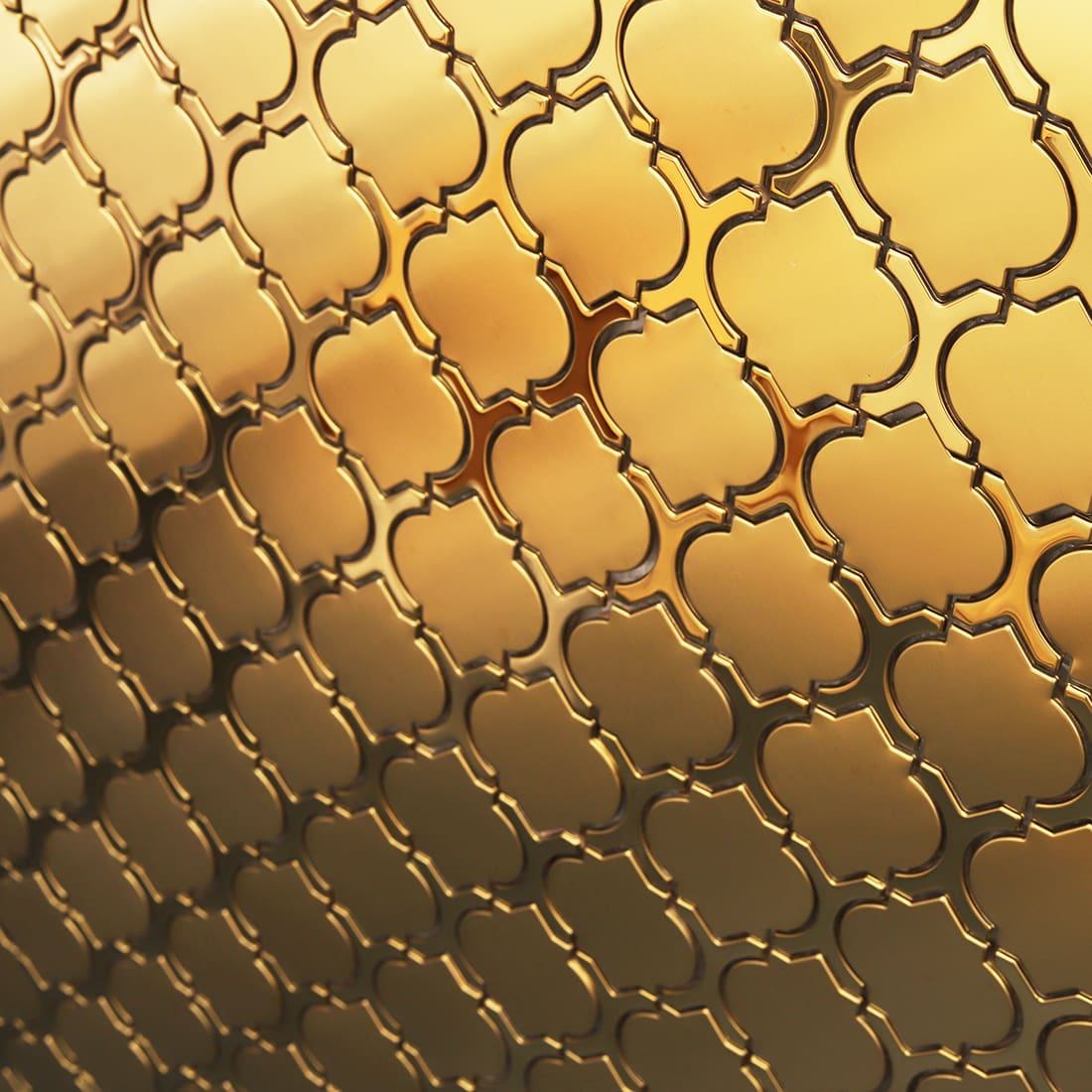 Angled view of gold arabesque metal mosaic wall with luxury shine