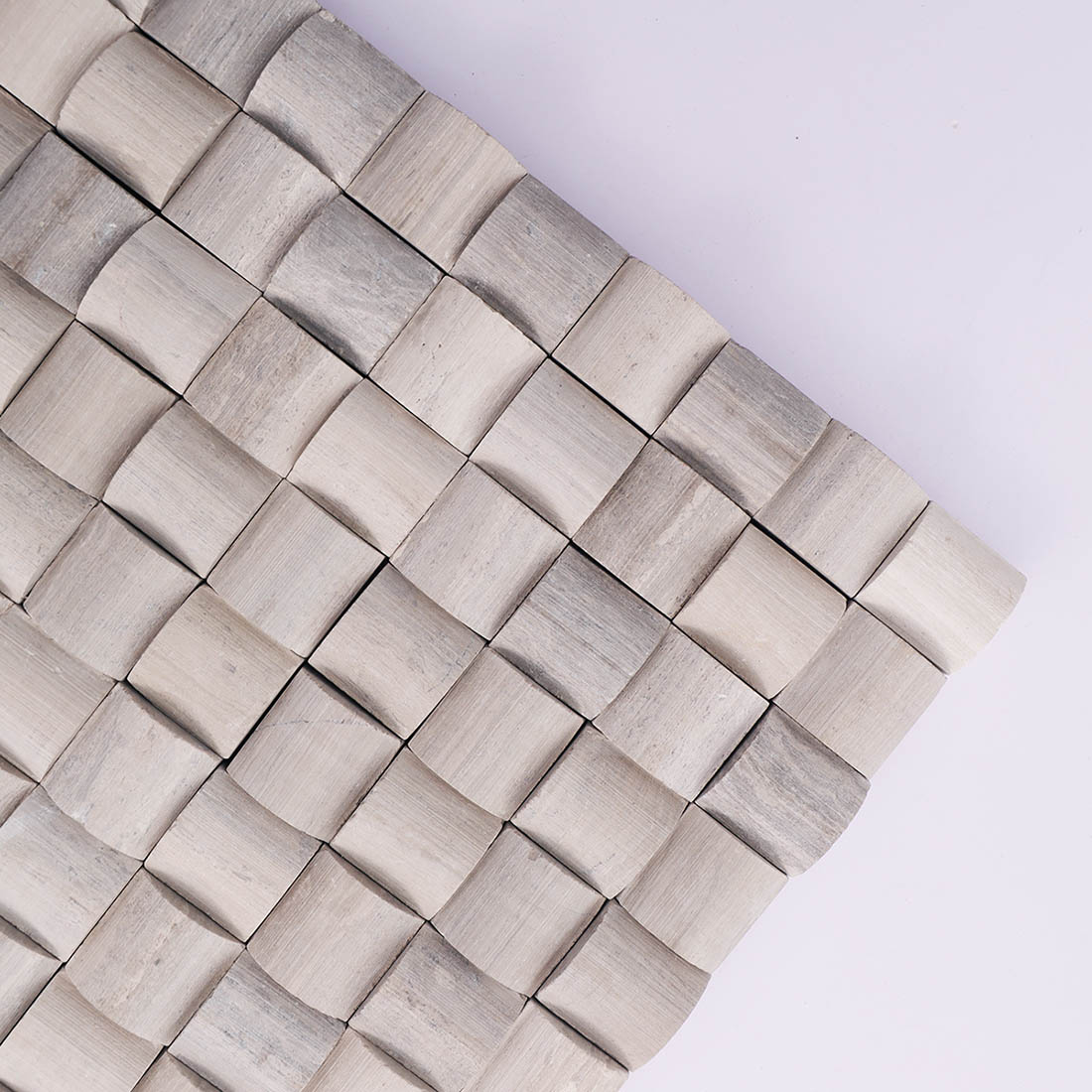 Corner detail of gray 3D square marble mosaic tile with curved surfaces