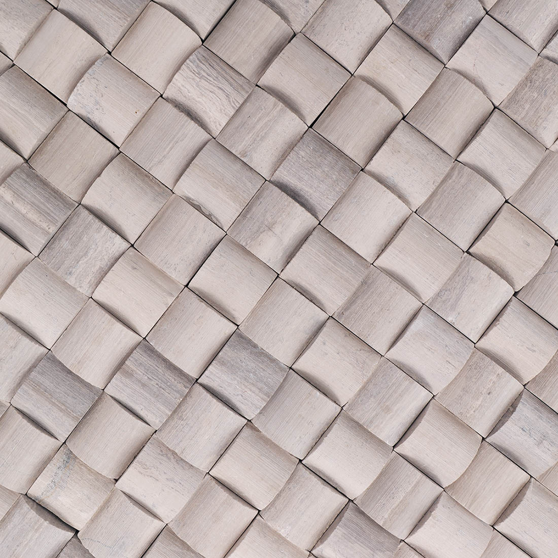 Close-up of gray 3D square marble mosaic tiles with sculpted texture